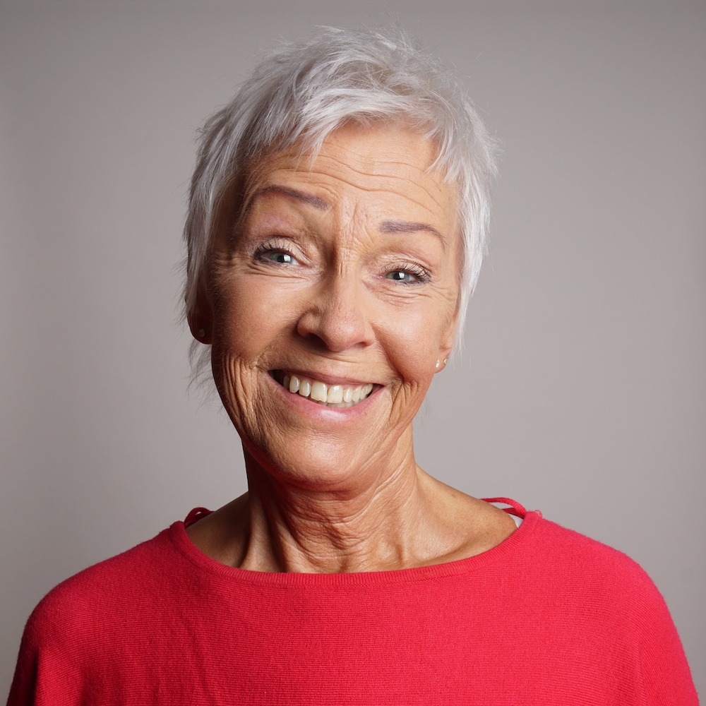 happy-older-woman-in-her-60s-with-trendy-short-whi-2021-10-01-18-39-16-utc.jpg